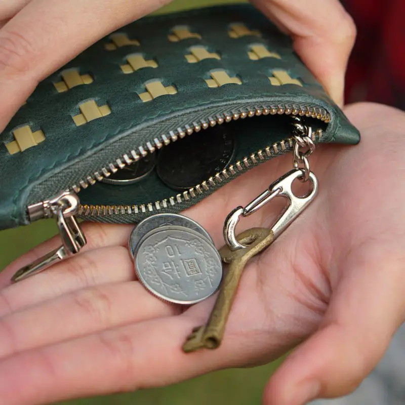 green zipper wallet hands key coins