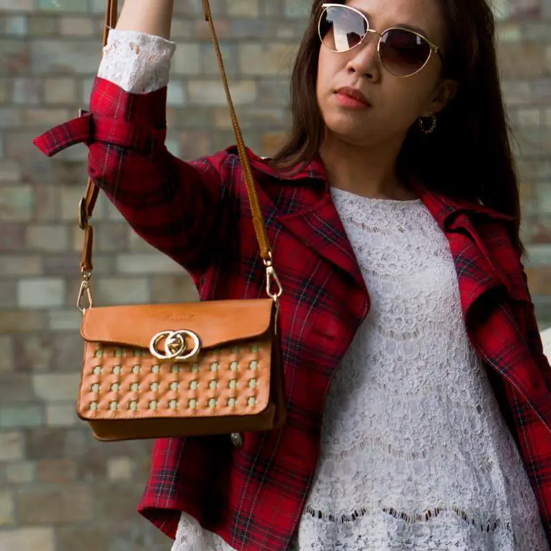 mini purse brown model strap in hand