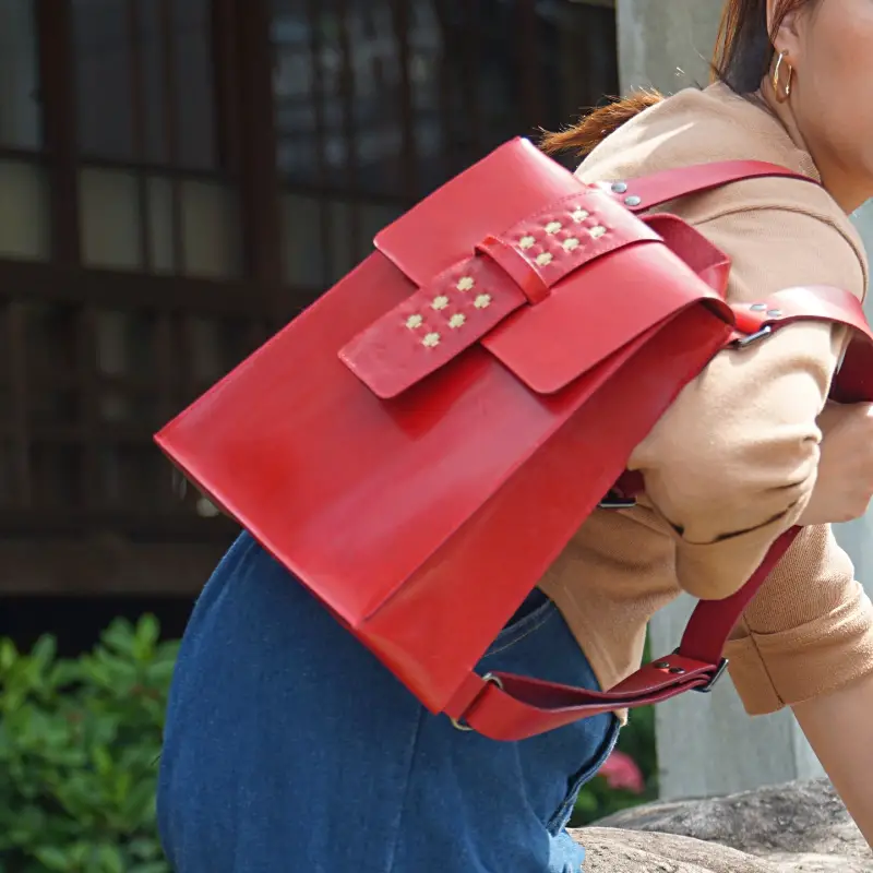 red mini backpack on shoulder